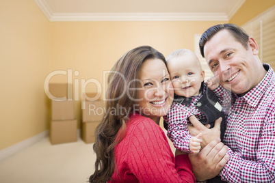 Young Family In Room With Moving Boxes
