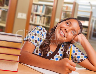 Hispanic Girl Student Daydreaming While Studying in Library