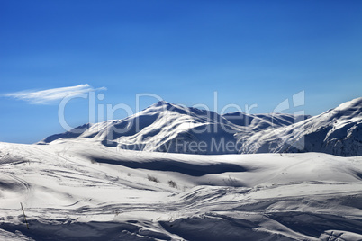 Off-piste ski slope in sunny evening