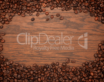 Espresso beans on an oak texture