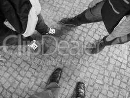 Three people feet in black and white