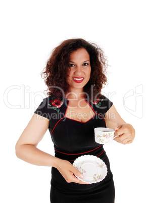 Woman holding coffee cup.