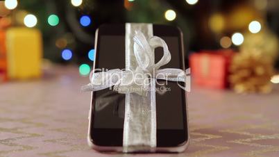 Smartphone with Christmas gifts and decorations