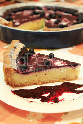 pie with bilberry on the plate and cup of tea