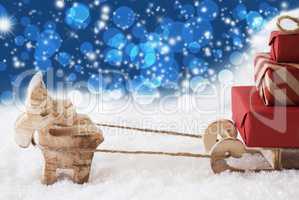 Reindeer With Sled, Blue Stars And Bokeh Background, Copy Space