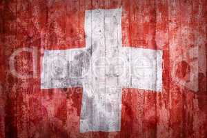 Grunge style of Switzerland flag on a brick wall