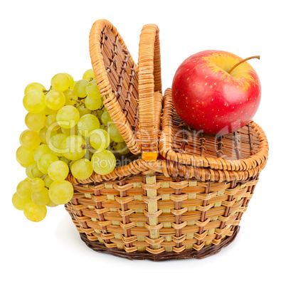 grapes and apple in the basket isolated on a white background