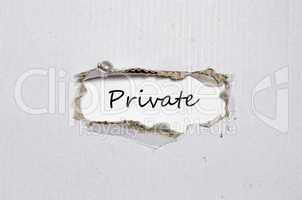 The word private appearing behind torn paper