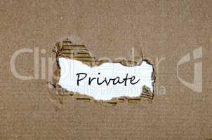 The word private appearing behind torn paper