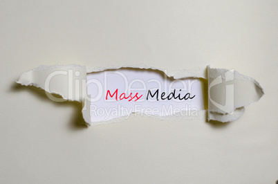 The word mass media appearing behind torn paper