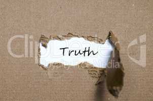 The word truth appearing behind torn paper