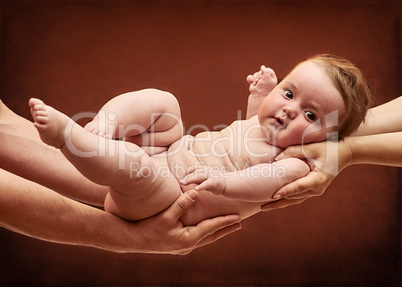 Parents Holding Baby Girl on their Arms