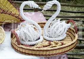 Decorative figurines of swans on a wicker platter.