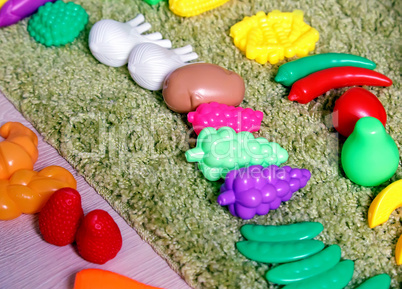 Plastic children's toys in the form of vegetables and fruits.