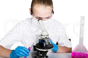 Attentive schoolgirl conducting a chemistry experiment at elementary science class. studying the bacteria through a microscope