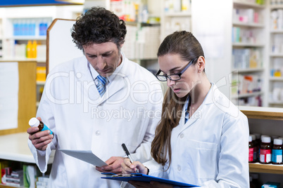 Pharmacists checking and writing prescription for medicine