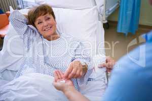 Nurse giving medication to patient