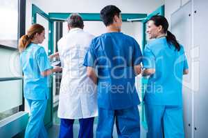 Rear view of doctor and surgeons interacting with each other