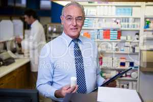 Pharmacist checking medicines