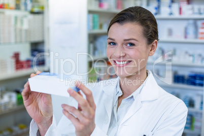 Pharmacist checking a medicine box in pharmacy