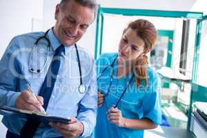 Doctor and nurse checking medical report