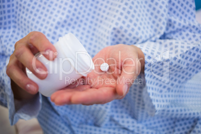 Close-up of senior patients hands holding medicine