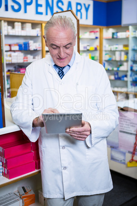 Pharmacist using a digital tablet