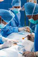 Surgeons performing operation in operation room