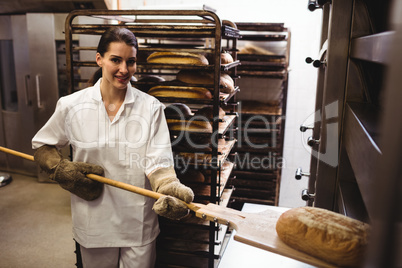 Female baker baking fresh bread
