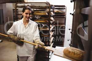 Female baker baking fresh bread
