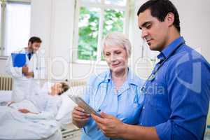 Doctor and nurse using digital tablet