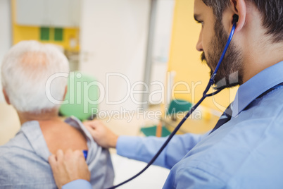 Male doctor examining a patient