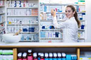 Pharmacist checking a medicine in pharmacy