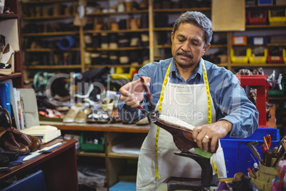 Shoemaker repairing a shoe