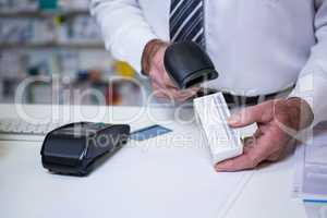 Pharmacist using barcode scanner on medicine box