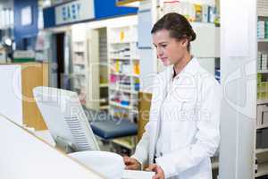 Pharmacist making prescription record through computer