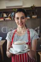 Female baker holding a cup of coffee