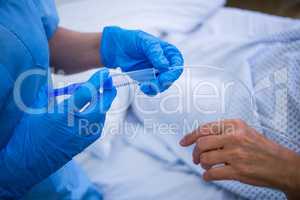 Nurse giving an injection to a patient