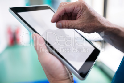 Surgeon using digital tablet in corridor