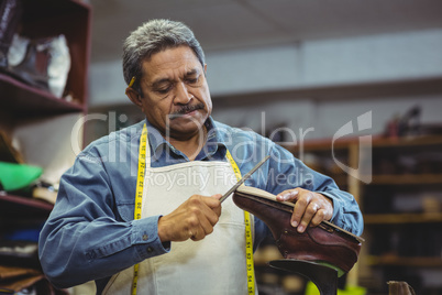 Shoemaker repairing a shoe