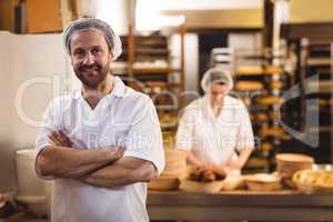 Portrait of male baker standing with arms crossed