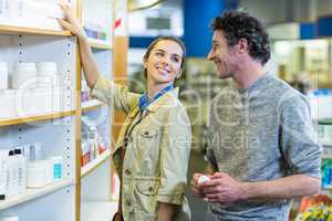 Couple checking a medicine on shelf in pharmacy