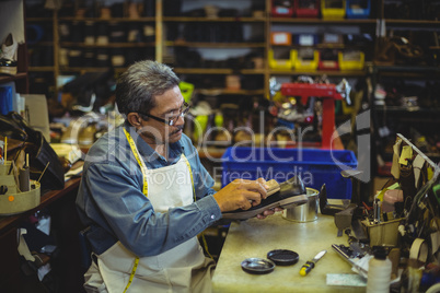 Shoemaker polishing a shoe