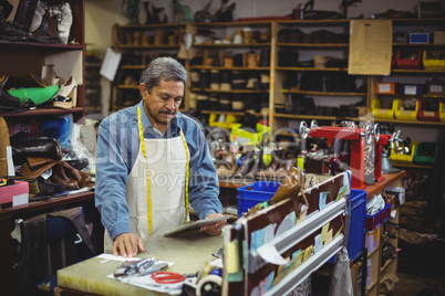 Shoemaker using digital tablet Shoemaker using digital tablet
