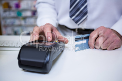 Pharmacist using payment terminal machine
