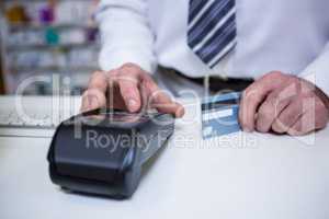 Pharmacist using payment terminal machine