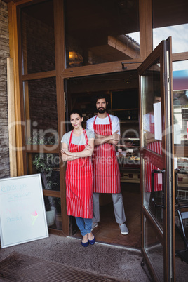 Portrait of couple standing with arms crossed