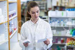 Pharmacist looking at prescription and medicine