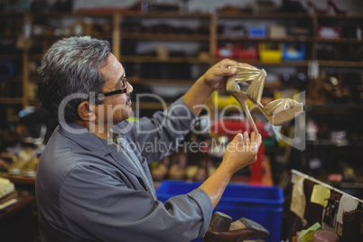 Shoemaker examining a high heel