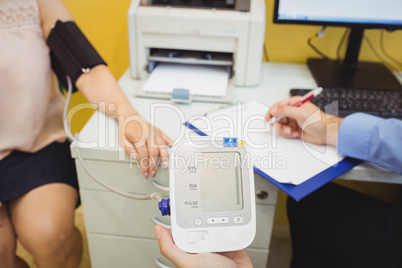 Doctor checking blood pressure of patient